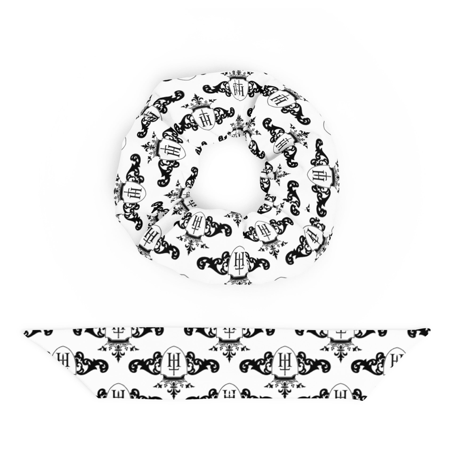 White scrunchie with black decorative crest patterns on a white background
