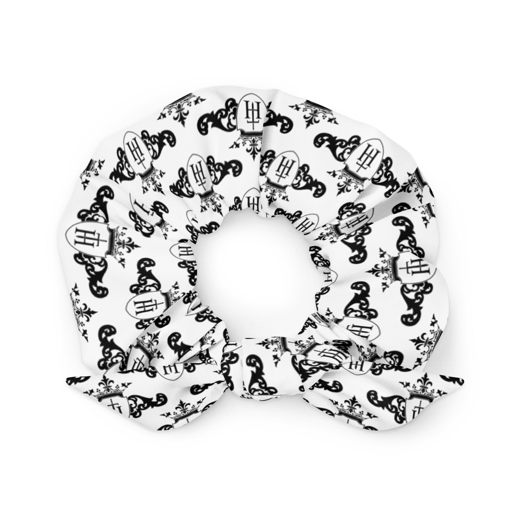 White scrunchie with black decorative crest patterns on a white background