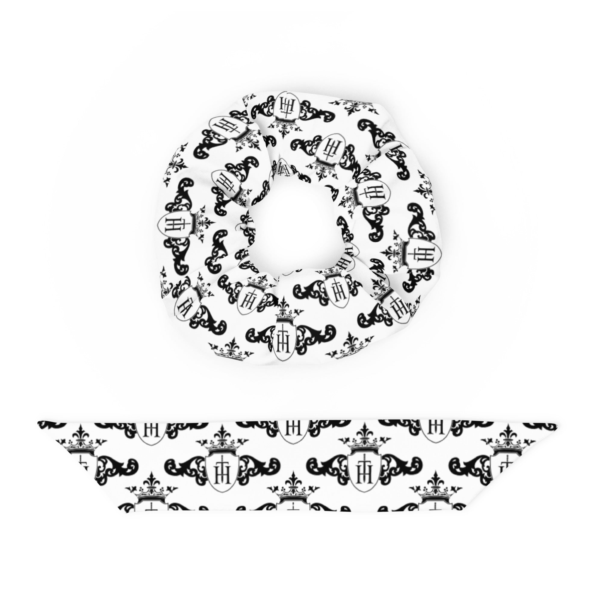 White scrunchie with black decorative crest patterns on a white background