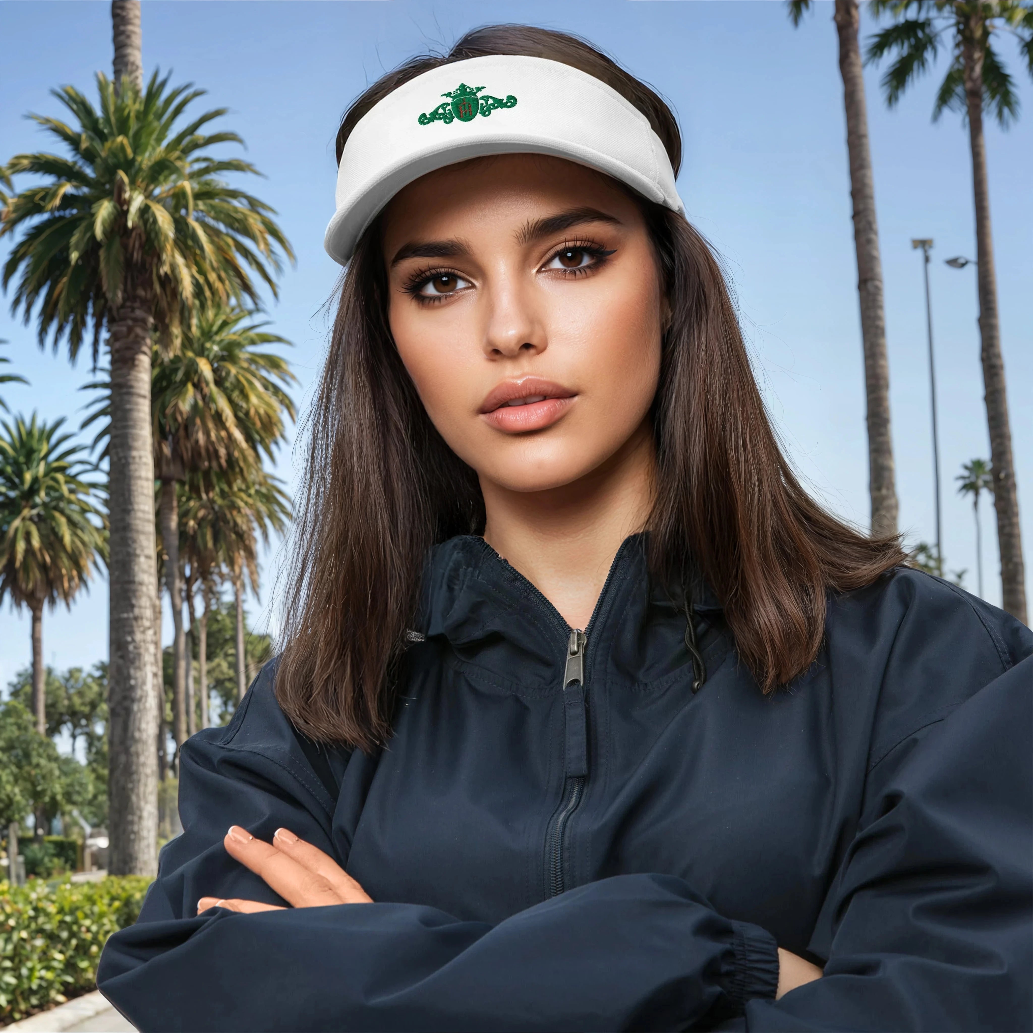 Woman wearing a white visor with a logo against a palm tree background