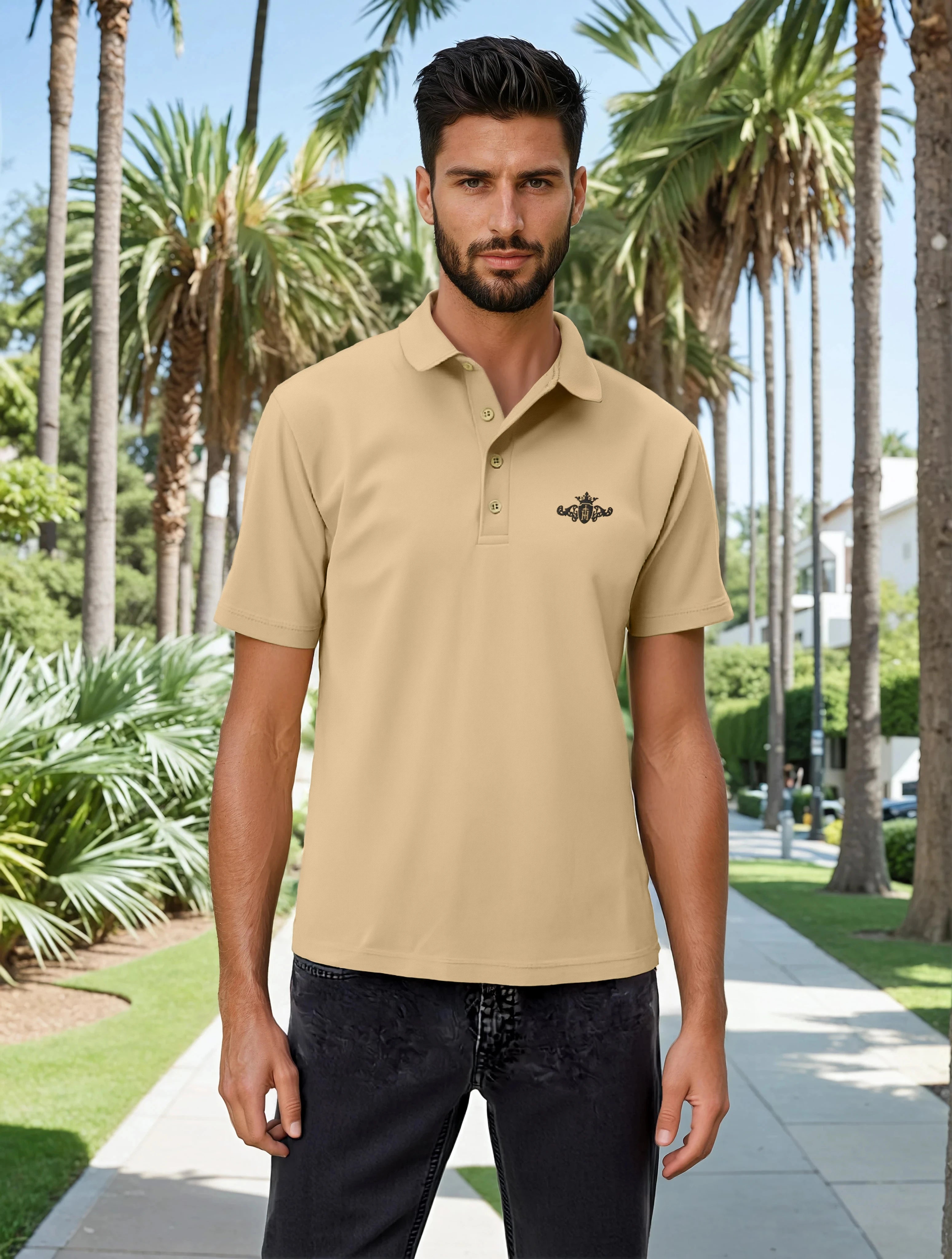 Man wearing a beige polo shirt with a logo in a tropical setting