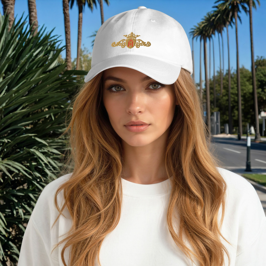 Woman wearing a white cap with a logo in a palm tree-lined street