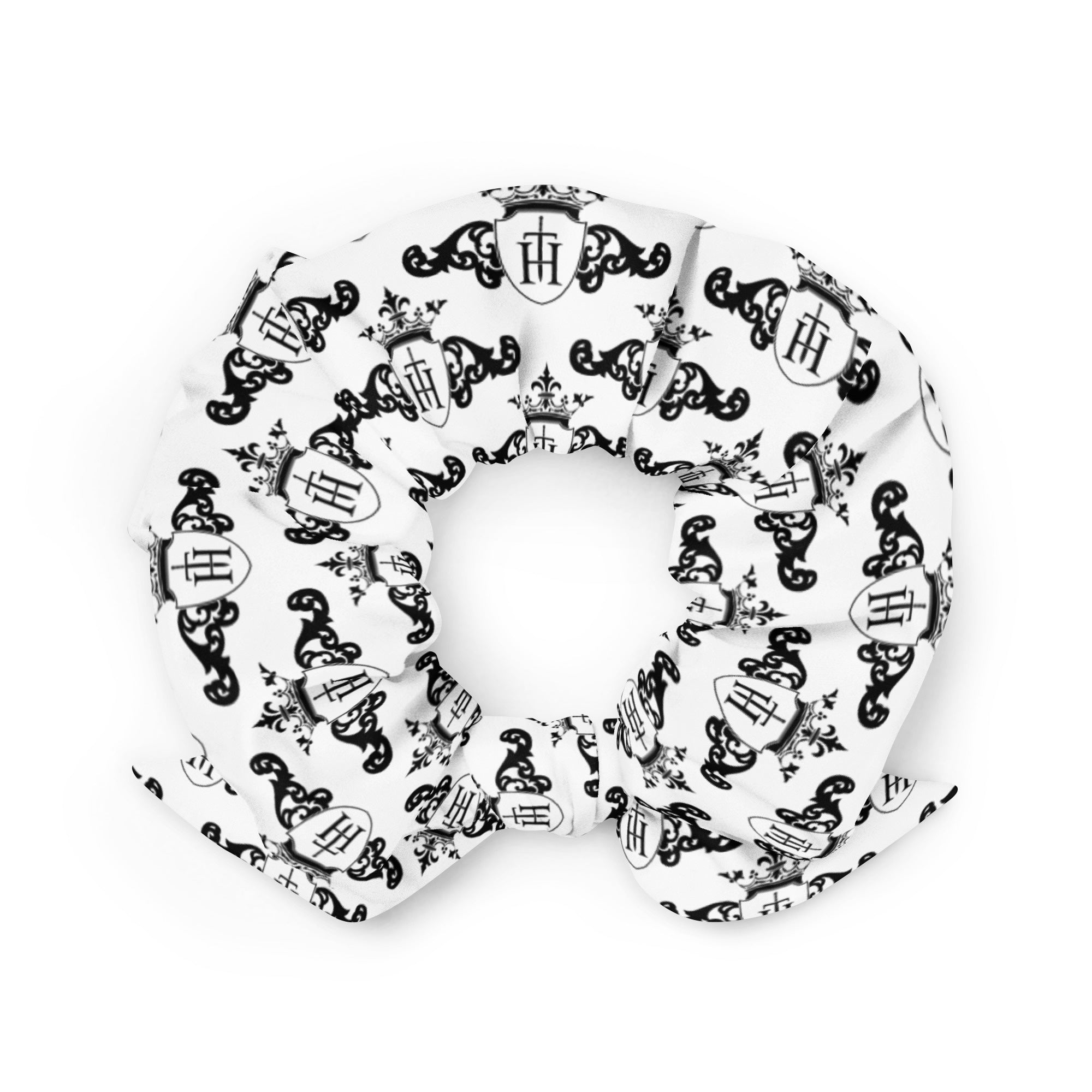 White scrunchie with black decorative crest patterns on a white background