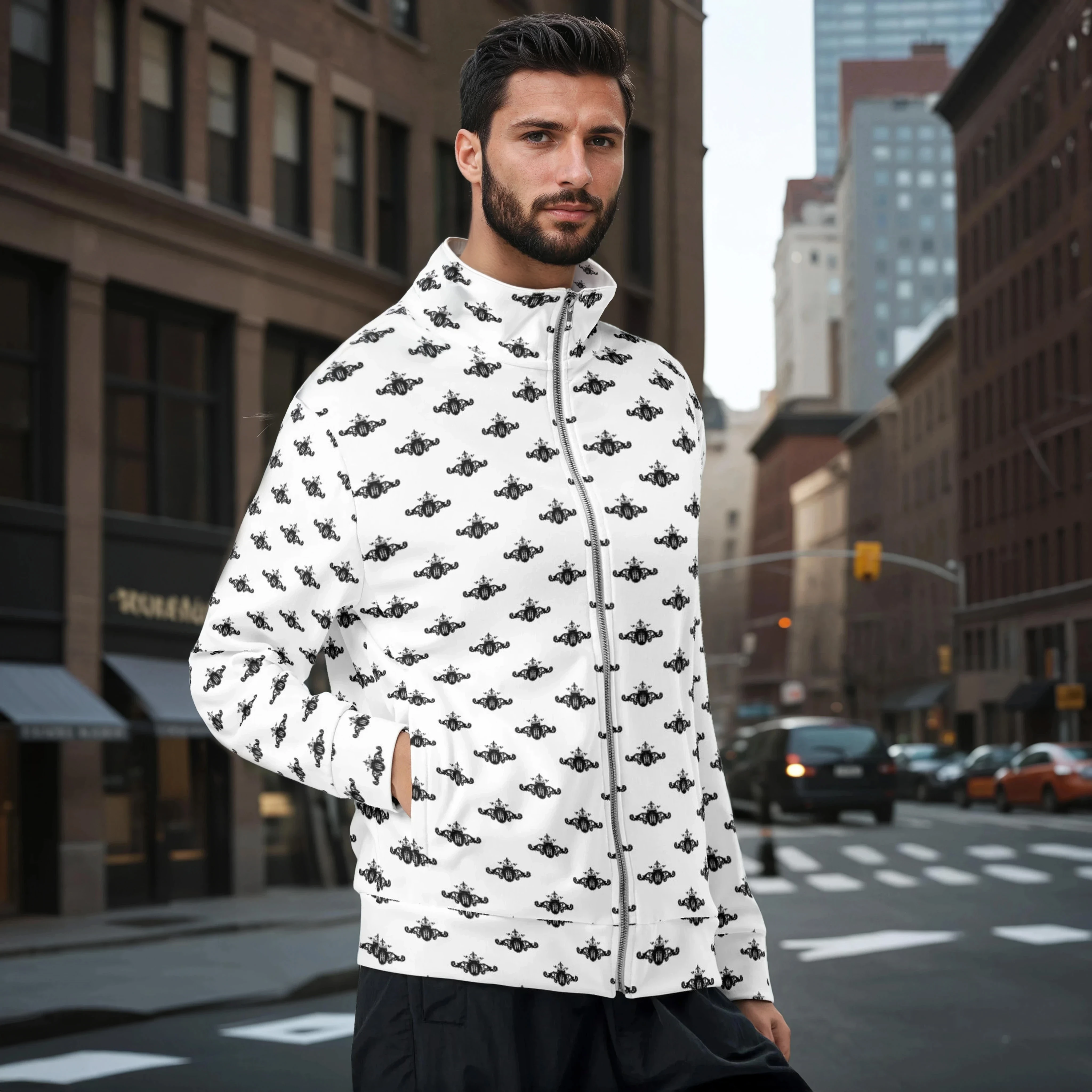 Man wearing a white jacket with black crest patterns on a city street