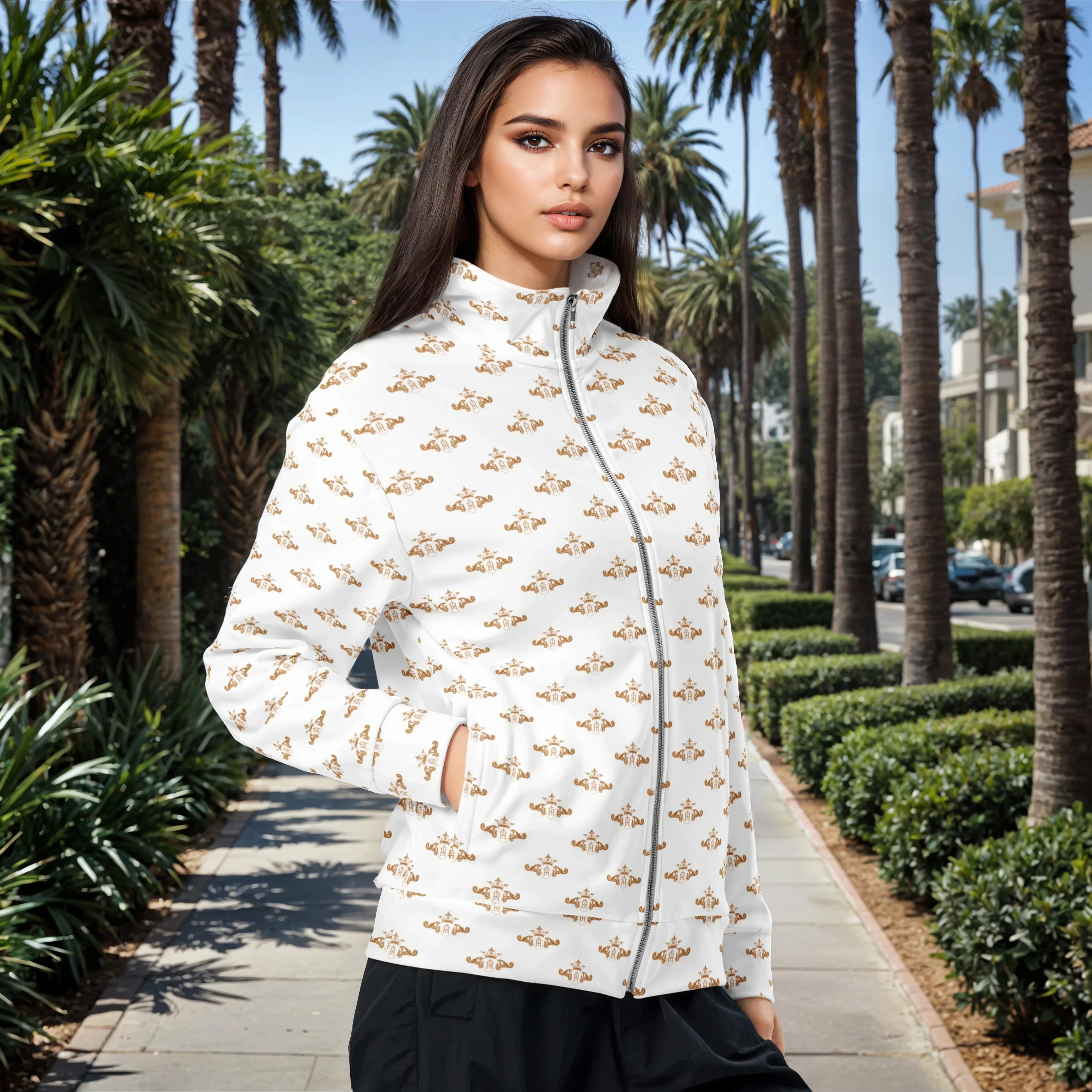 Woman wearing a white jacket with gold patterns in a palm tree-lined street.