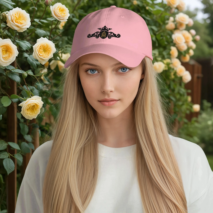 Woman wearing a pink cap with a floral design in a garden setting