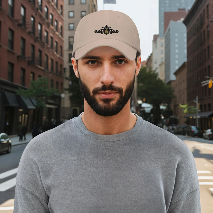 Man wearing a beige cap with a unique crest on a city street