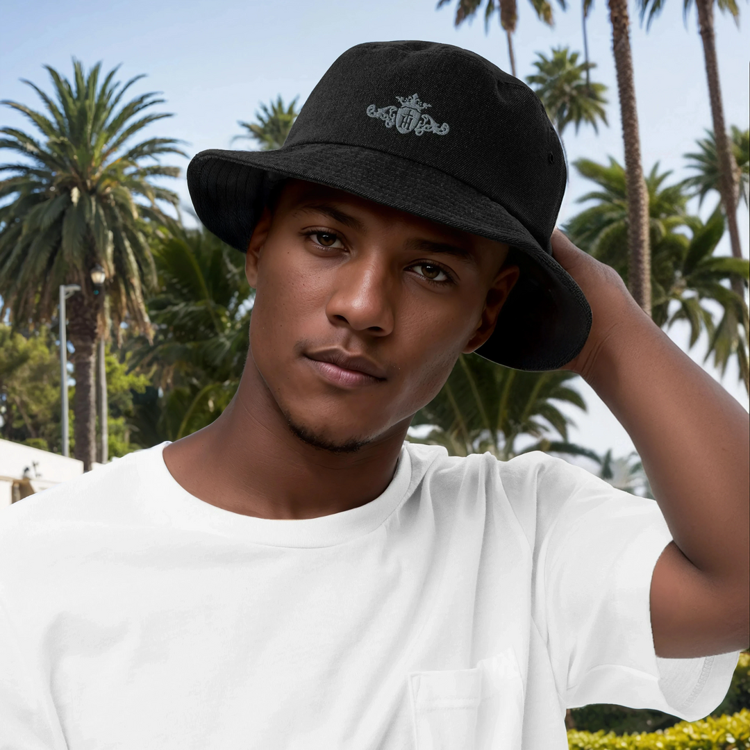 Man wearing a black bucket hat with a palm tree background