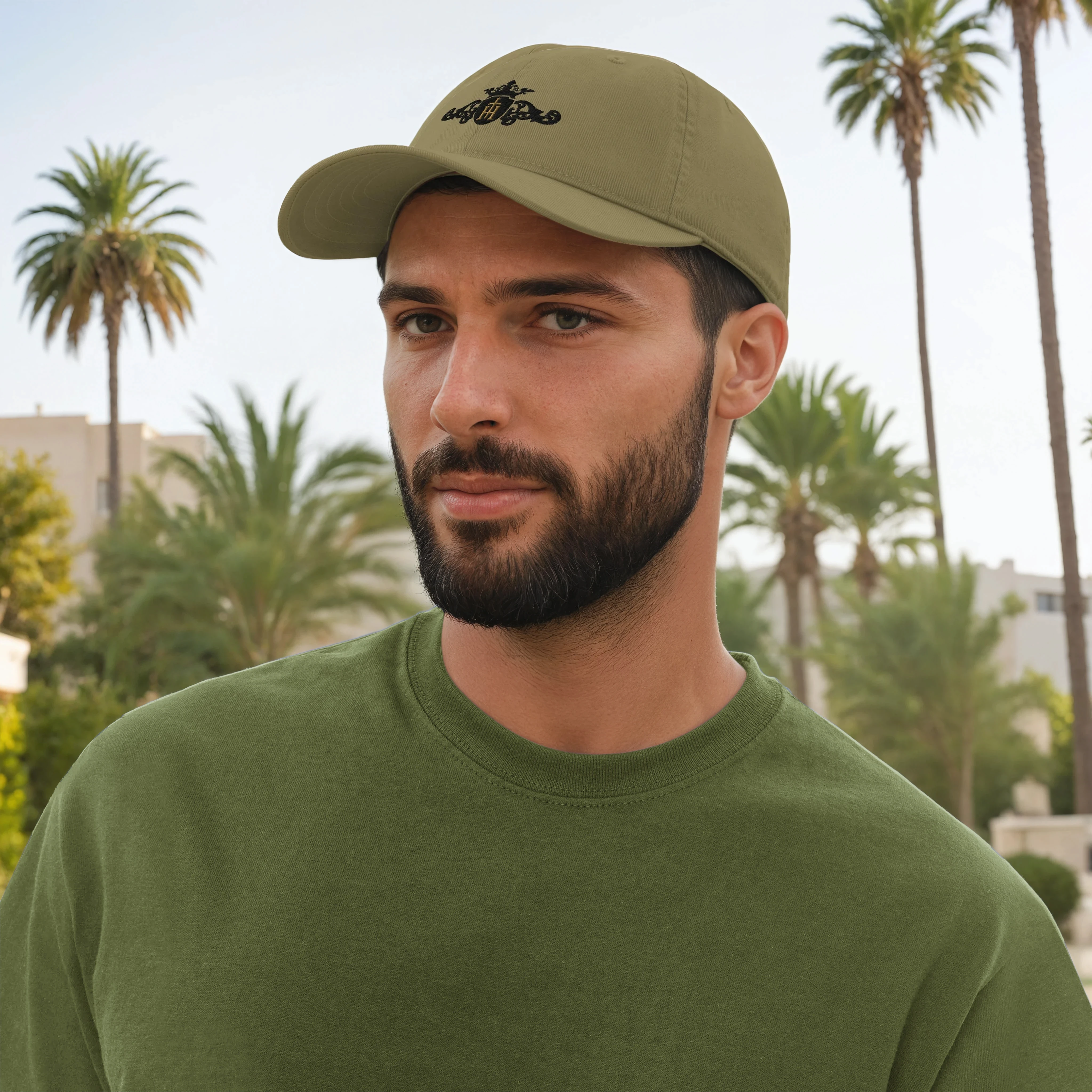Man wearing a green cap and shirt with palm trees in the background