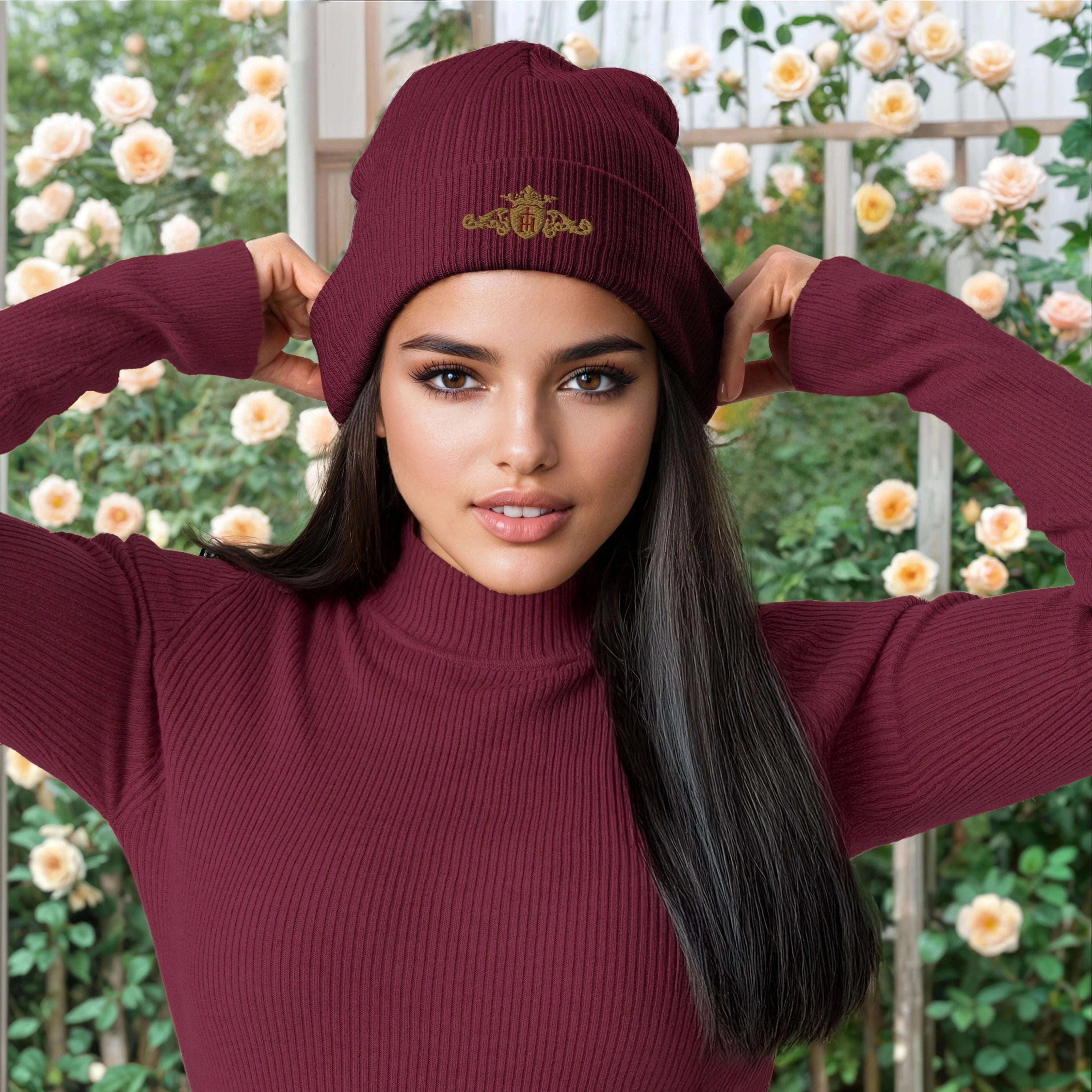 Woman wearing a maroon beanie and sweater with a floral background