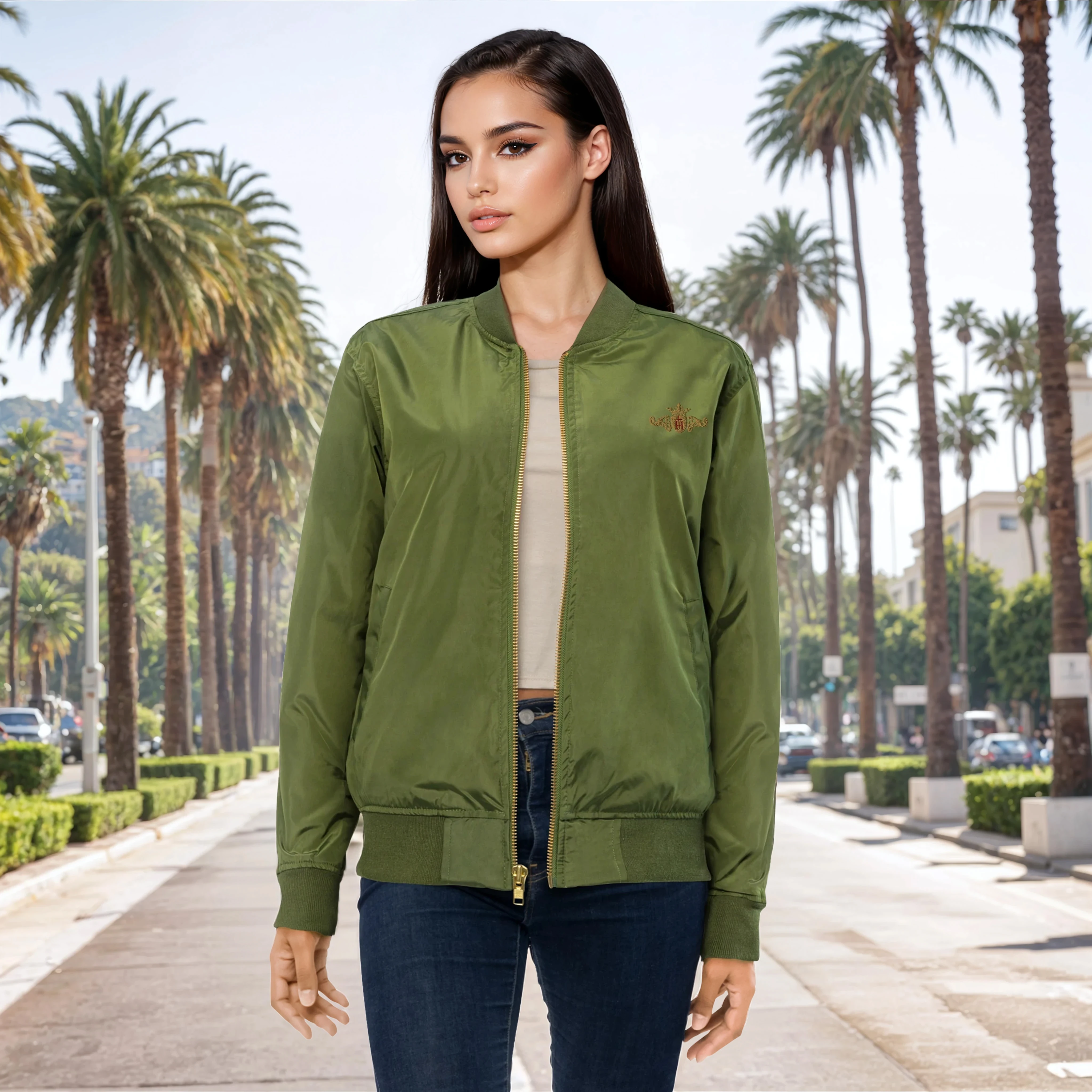 Woman wearing a green bomber jacket in a palm tree-lined street