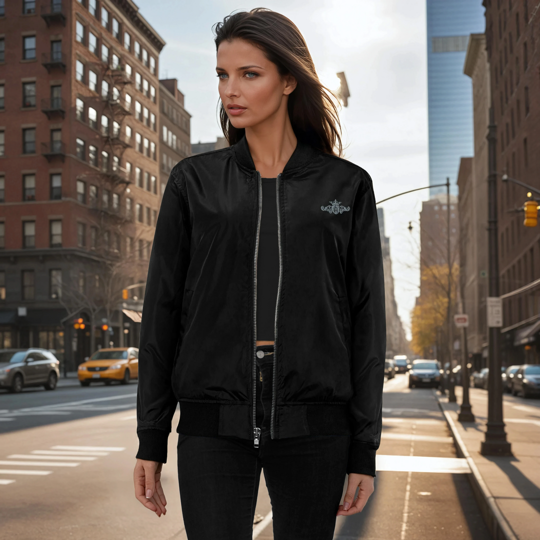 Woman wearing a black bomber jacket on a city street