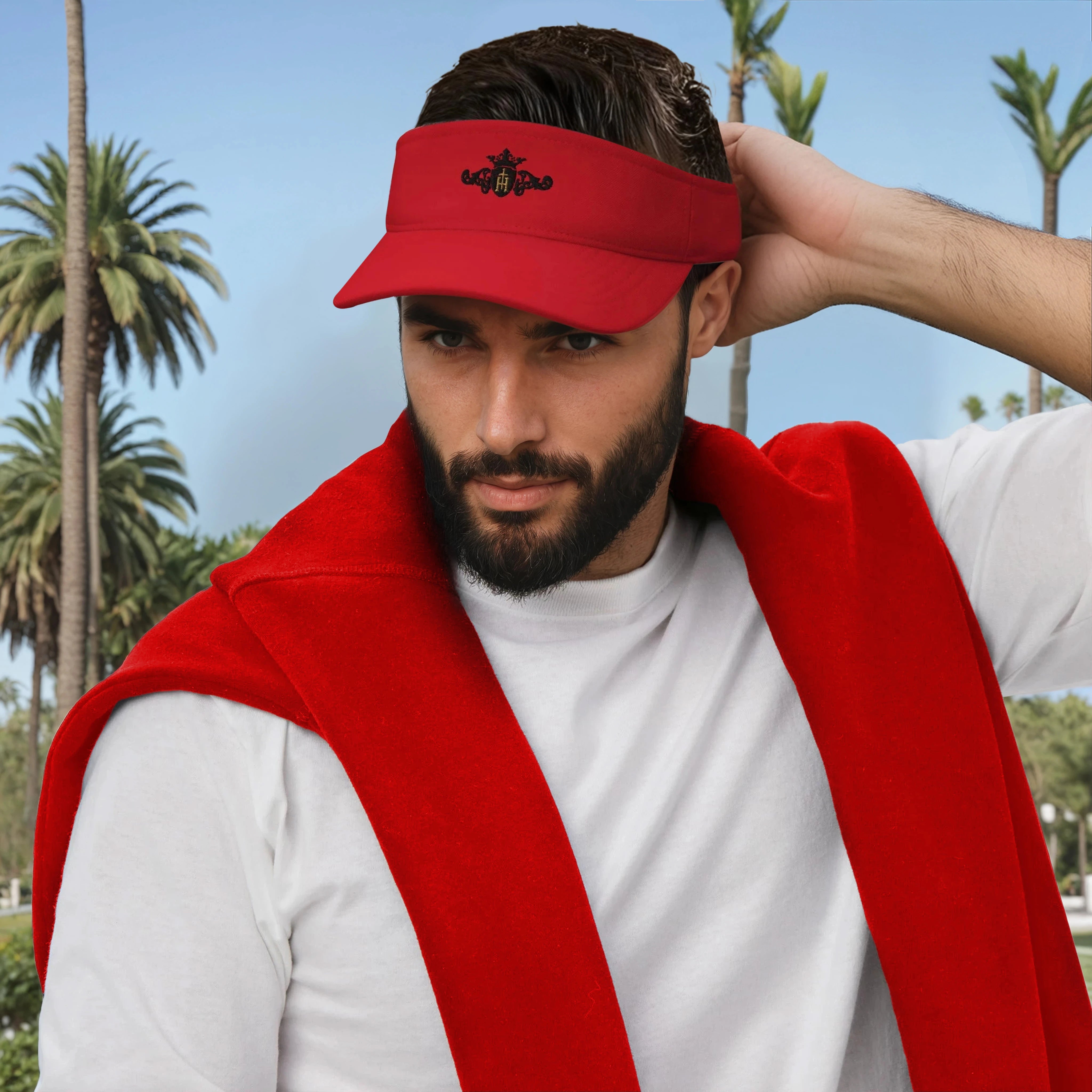 Man wearing a red visor and red vest with palm trees in the background